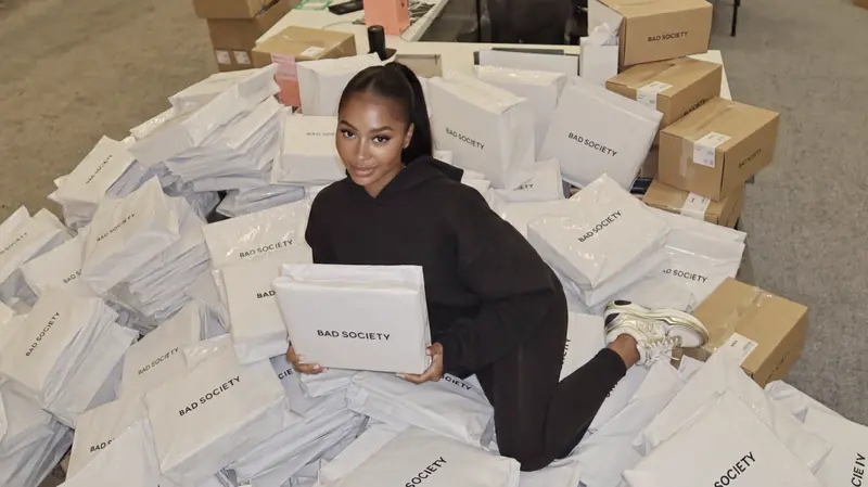 Founder surrounded by Bad Society packaging orders
